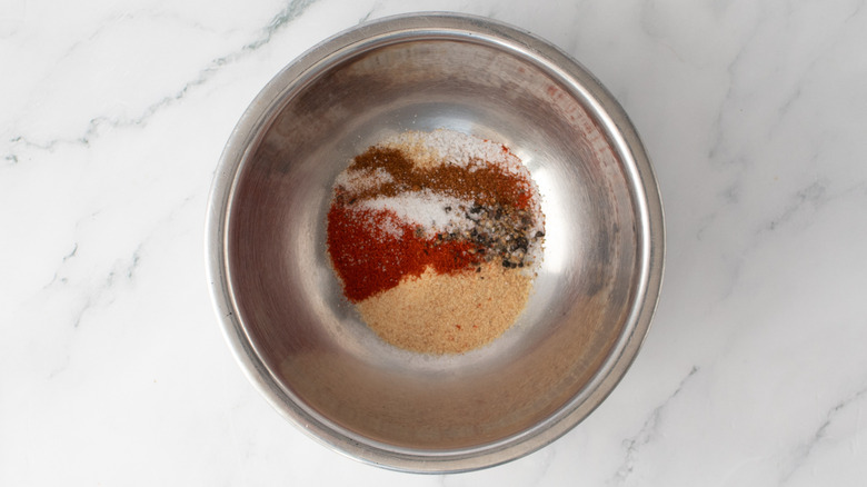 mixed dry seasonings in a metal bowl