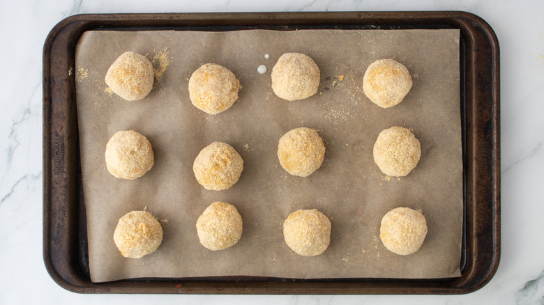 breaded cheese balls in a baking pan