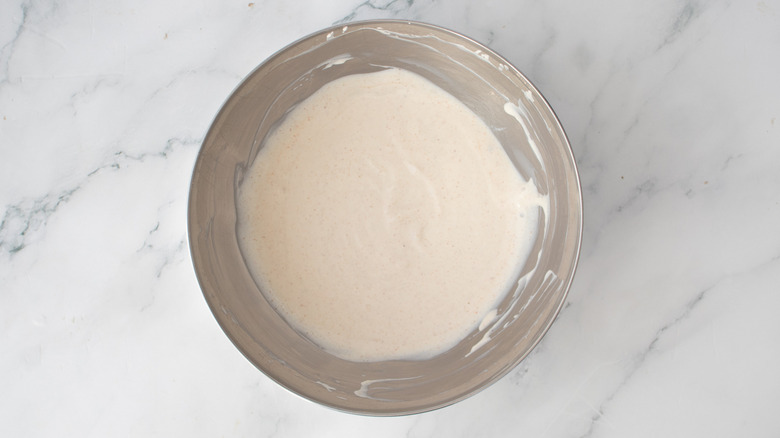 creamy white condiment in a metal bowl