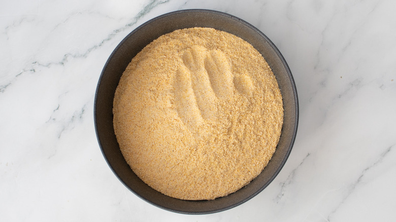 seasoned cornmeal breading mix in a metal bowl