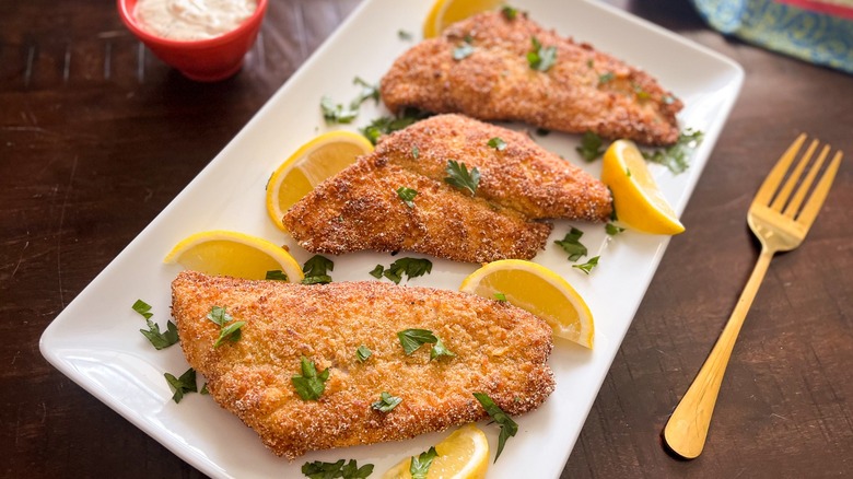 fried catfish with lemon wedges