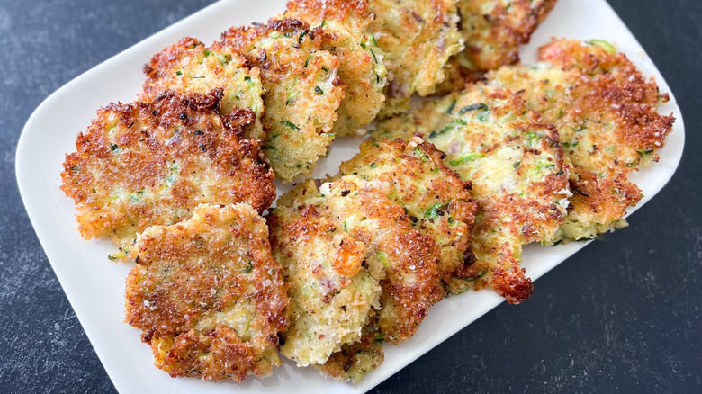 Fried zucchini fritters on plate