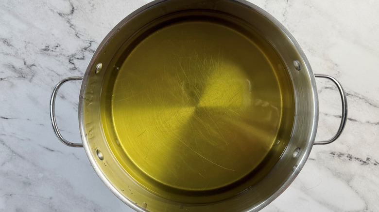 large quantity of oil in a metal pot