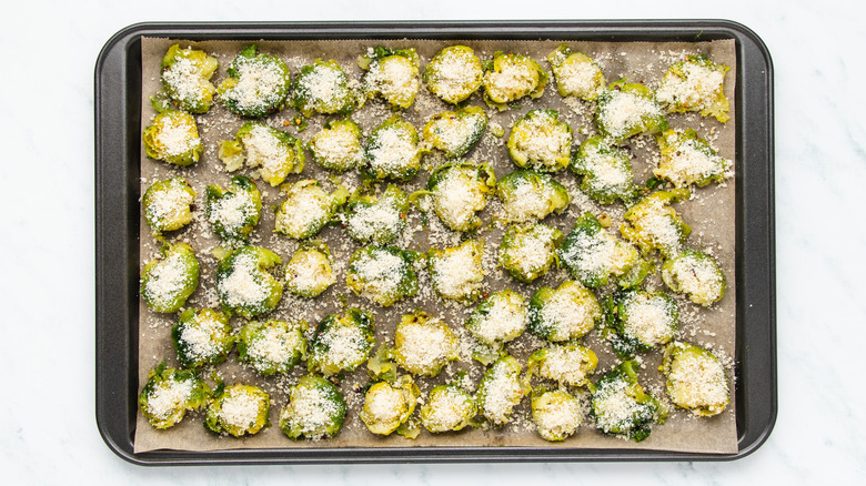 Cheesy smashed Brussels sprouts on baking sheet