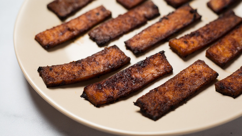 vegan bacon on beige dish