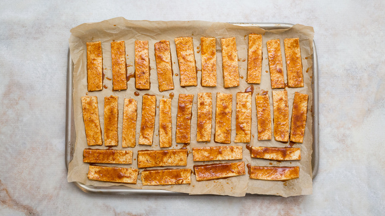 coated tofu slice in pan