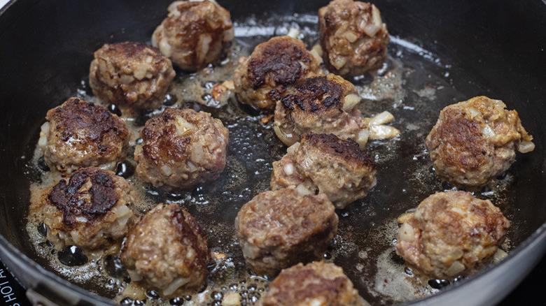 meatballs cooking in pan 