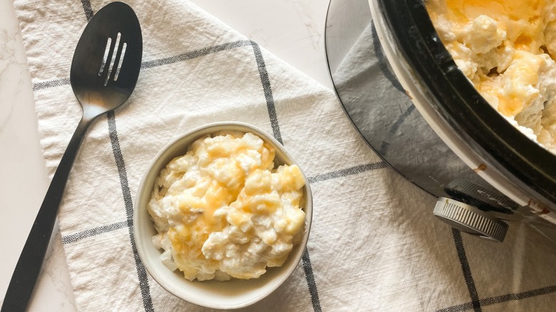 Funeral potatoes in bowl and crockpot