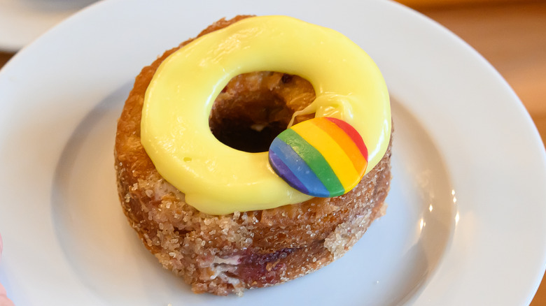 Yellow cronut with a pride flag