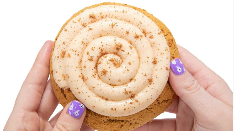 Holding Crumbl Caramel Pumpkin cookie