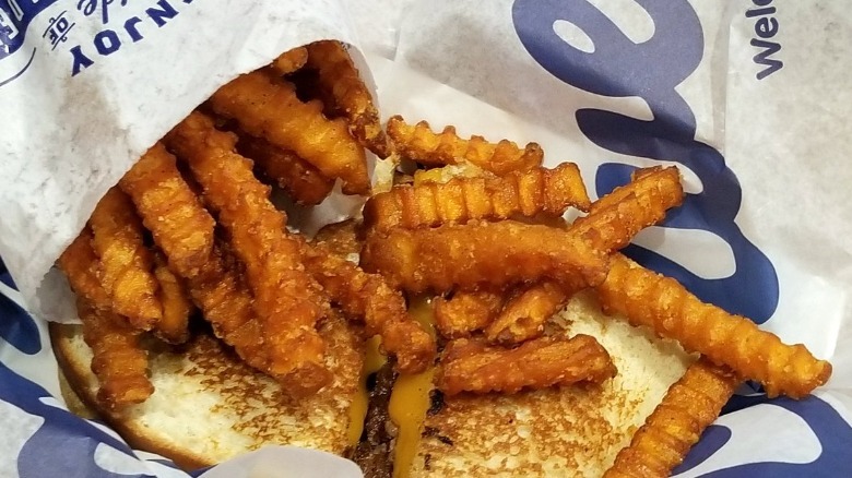 Culver's Sweet Potato Fries in basket with sandwich