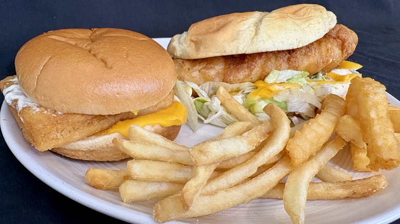 Culver's and McDonald's fish sandwiches with fries on a white plate