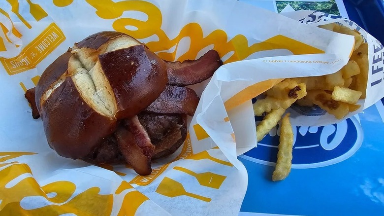 Toasted pretzel bun with bacon and fries from Culver's