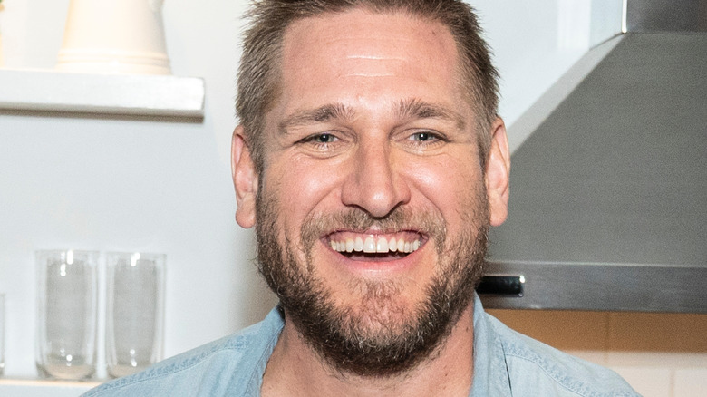 Curtis Stone smiling in kitchen