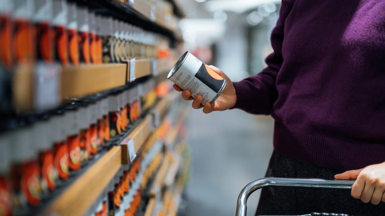 shopper looking at canned goods