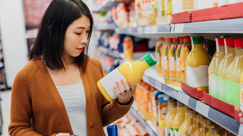 woman shopping for orange juice