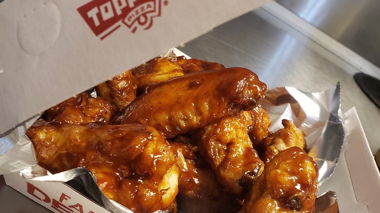 Barbecue chicken wings in a Toppers Pizza takeout box.