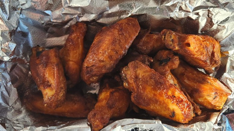 Hungry Howie's buffalo wings in aluminum foil.