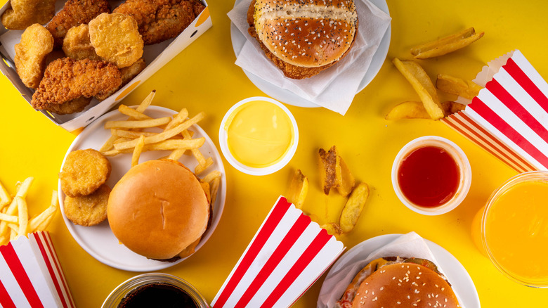 An assortment of fried chicken sandwiches, tenders, and nuggets with dipping sauces.