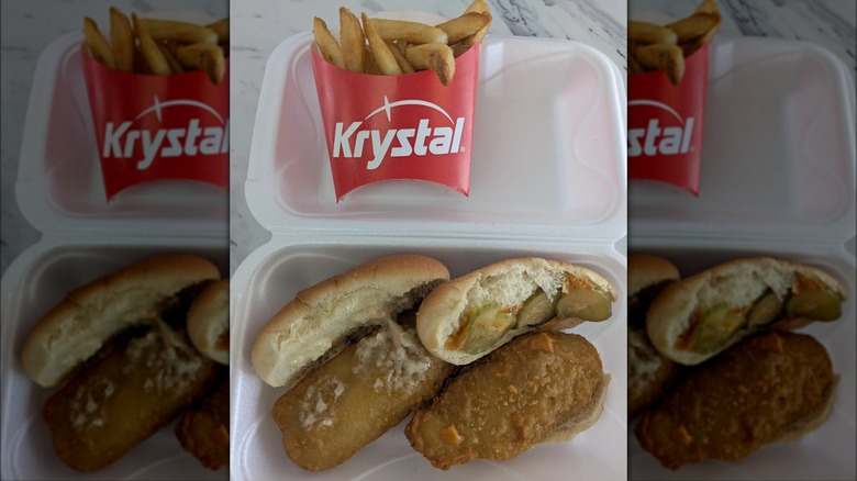 A to-go container with fish sliders and fries from Krystal.