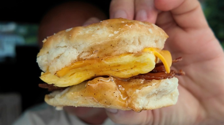 A closeup shot of McDonald's Honey Brown Butter Bacon, Egg, and Cheese Biscuit.