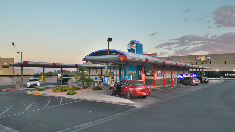 A Sonic drive-in restaurant, with five cars in the lot.