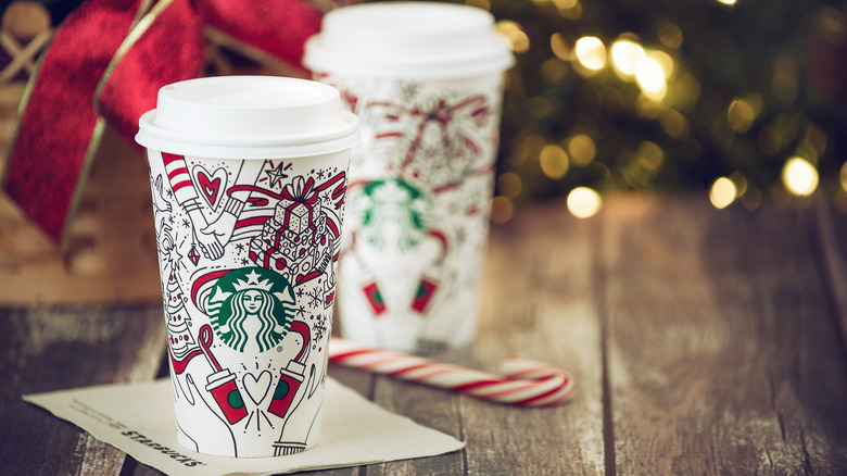 two Starbucks holiday cups