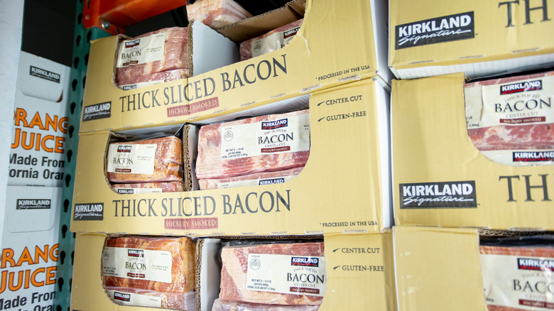 Packs of Kirkland Signature thick sliced bacon stacked in a walk in freezer
