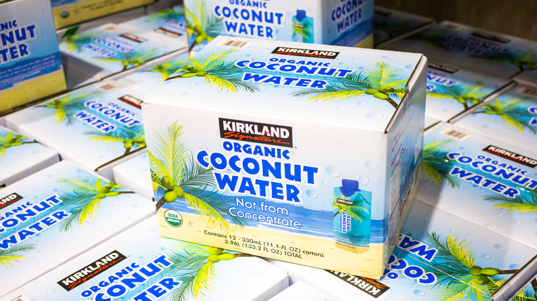 A single box Kirkland Signature coconut water on top of other boxes