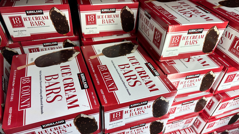 Stacks of red and white Kirkland Signature ice cream bar boxes in a freezer