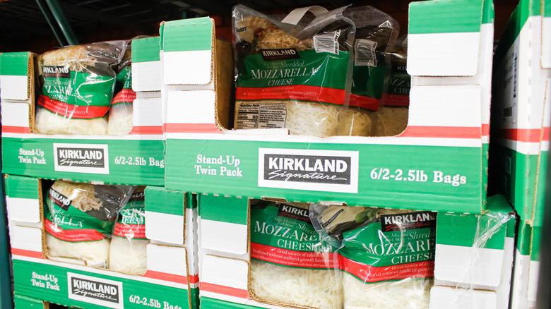 Bags of Kirkland Signature shredded mozzarella in green, red, and white cardboard bozes
