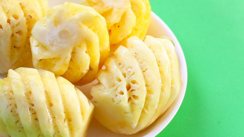 Spiral-cut pineapples on white plate.