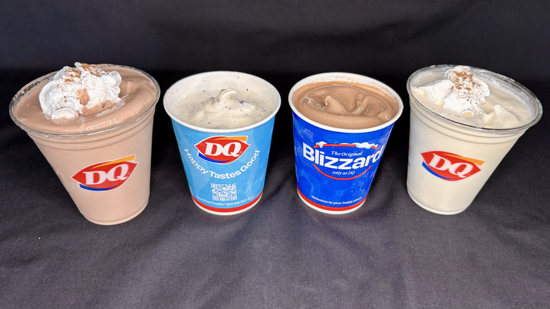 two Dairy Queen Blizzards and two shakes on black background