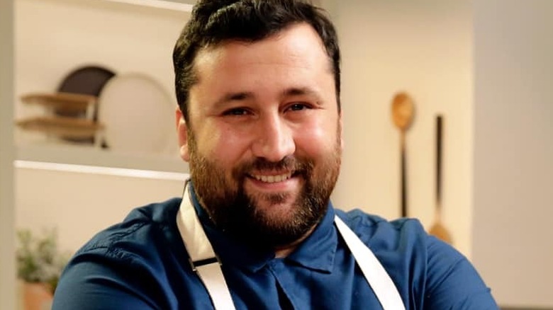 Daniele Uditi smiling in the kitchen