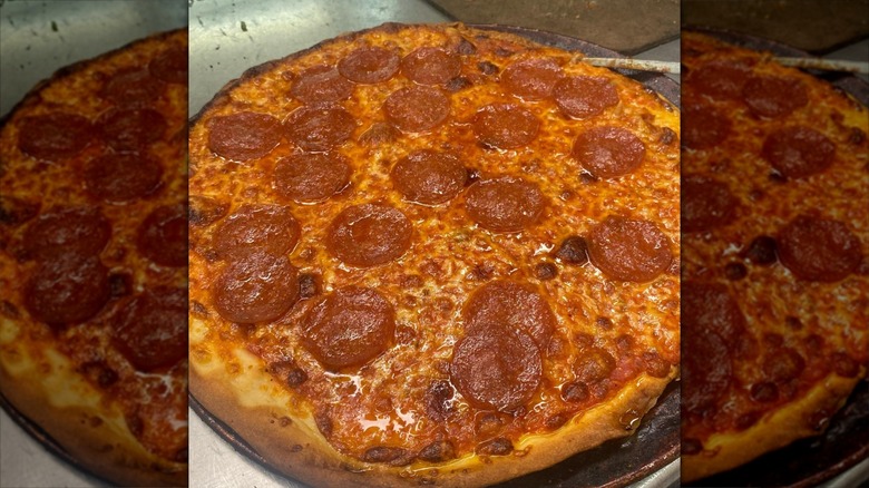 Pepperoni pizza on a stainless steel pan
