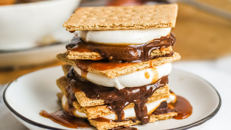 Stacked oven-baked s'mores with melted chocolate and gooey marshmallow between layers of graham cracker