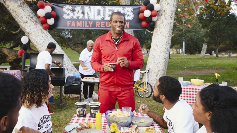 deion sanders in red tracksuit