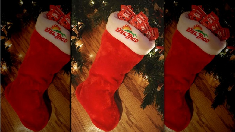 Del Taco red stocking filled with mild sauce