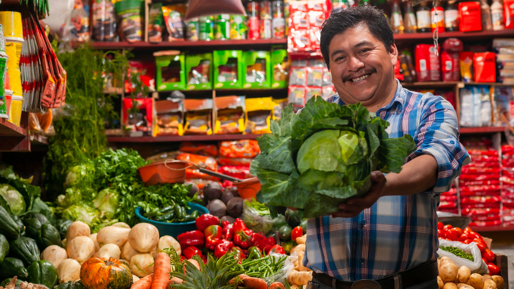 happy man selling cabbage