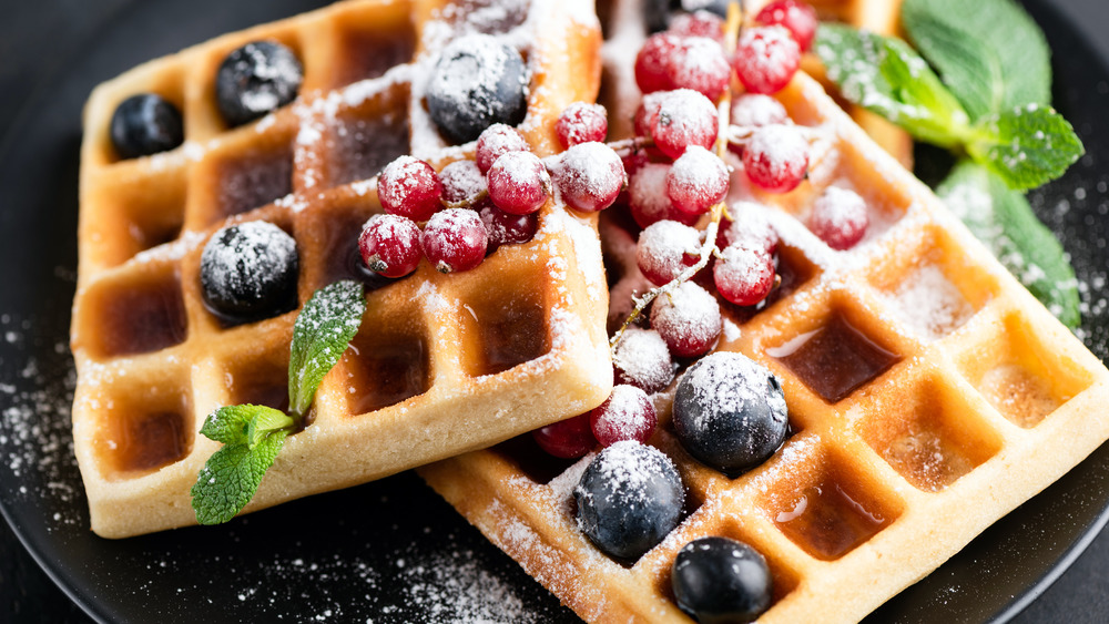 Waffles topped with berries still on vine