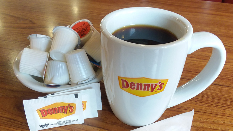 Coffee in a Denny's branded cup setting on a table