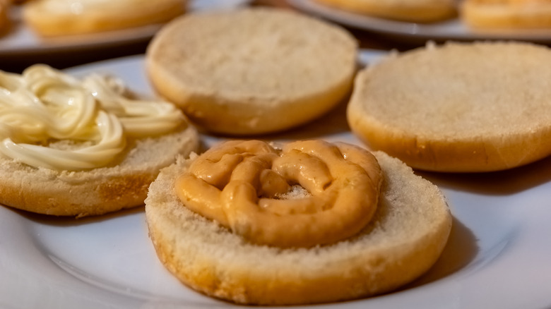 Hamburger buns topped with peanut butter and mayonnaise