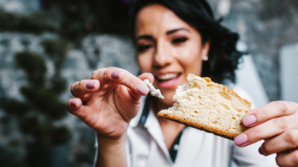 happy woman holds bread