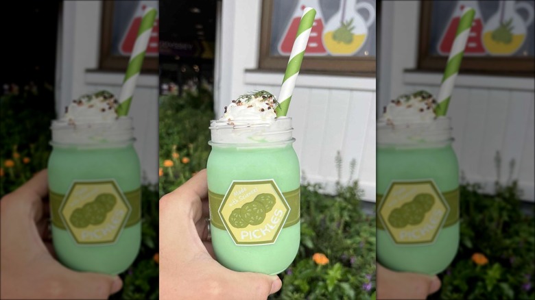 hand holding pickle milkshake