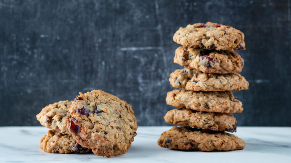 cranberry orange oatmeal cookies stacked on a white counter