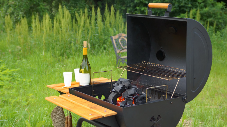 barrel grill with bottle of wine