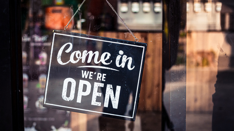 "Come In, We're Open" sign on restaurant door