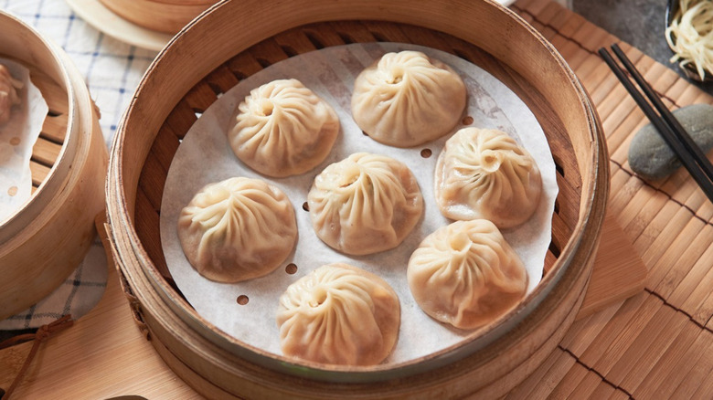 dumplings sitting in bamboo steamer 