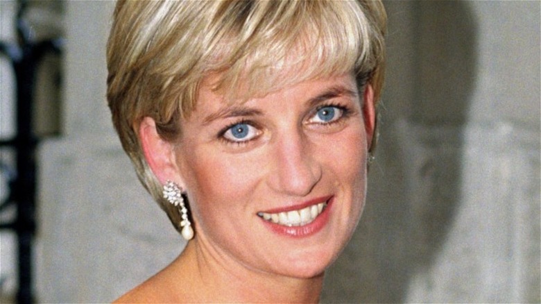 Princess Diana, smiles with pearl earrings