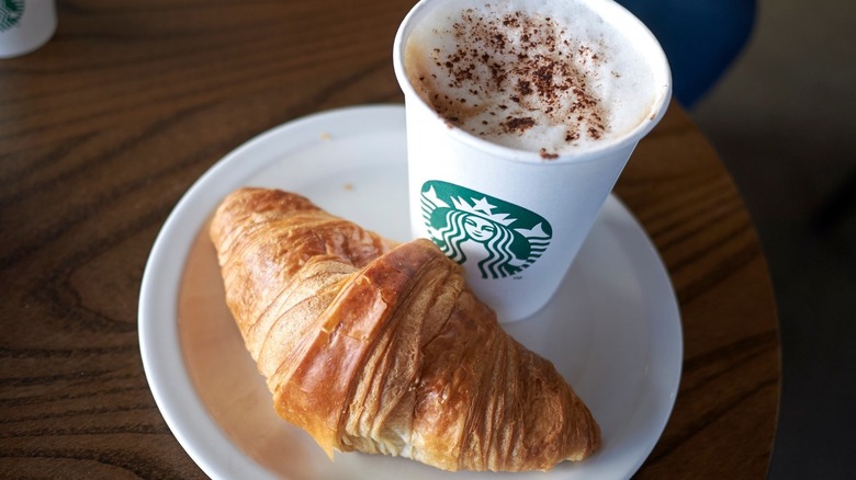 starbucks coffee cup and croissant